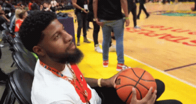 A Man Holding A Wilson Basketball On A Court GIF