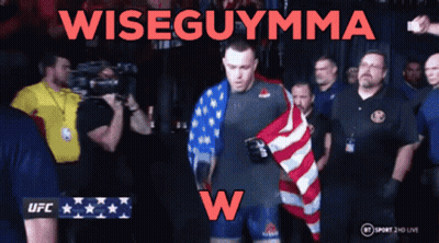 A Man Holding An American Flag With The Words Wiseguymma On The Bottom GIF