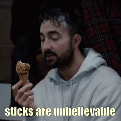 A Man Holding An Ice Cream Cone With The Words " Sticks Are Unbelievable " On The Bottom GIF