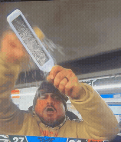 A Man Holding Up A Knife In Front Of A Scoreboard With The Number 27 On It GIF