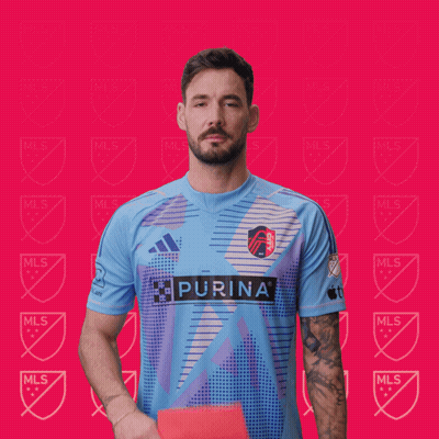 A Man Holding Up A Red Card That Says Purina GIF