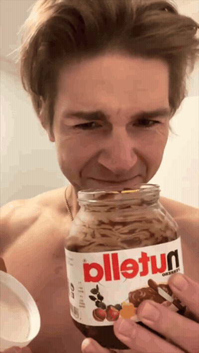 A Man Holds A Jar Of Nutella In His Hand GIF