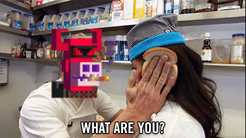 A Man Holds A Slice Of Bread Over A Woman 'S Ear And Says " What Are You " GIF