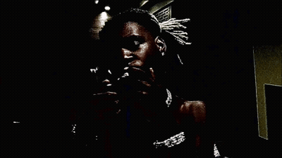 A Man Holds A Stack Of 100 Dollar Bills In His Mouth GIF