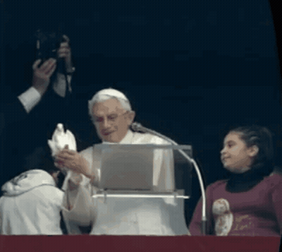 A Man Holds A White Dove In Front Of A Microphone GIF