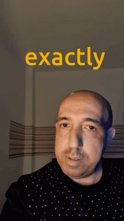 A Man Holds His Finger To His Nose In Front Of A Sign That Reads Exactly GIF