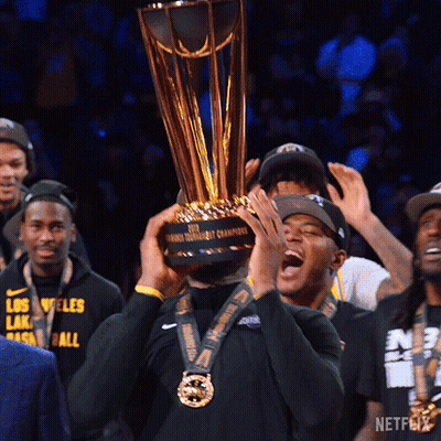 A Man Holds Up A Trophy That Says Netflix On It GIF