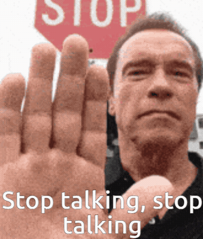 A Man Holds Up His Hand In Front Of A Red Stop Sign GIF