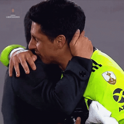 A Man Hugging Another Man With The Word Libertadores In The Corner GIF
