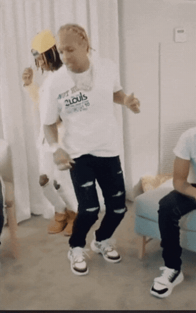 A Man In A 2Louis Shirt Is Dancing GIF