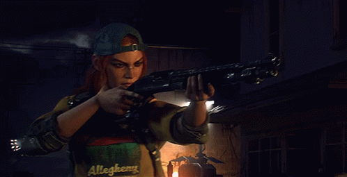 A Man In A Allegheny Shirt Is Holding A Gun GIF