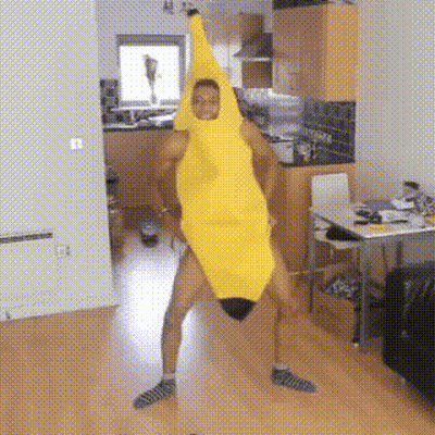 A Man In A Banana Costume Is Dancing In A Kitchen . GIF