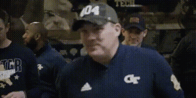 A Man In A Baseball Cap Is Holding A Bottle Of Medicine In His Hand . GIF