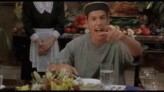 A Man In A Baseball Cap Is Sitting At A Table With A Glass Of Water And A Plate Of Food . GIF