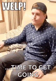A Man In A Baseball Cap Is Sitting On A Couch With A Dog . GIF