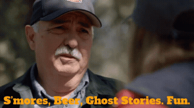 A Man In A Baseball Cap Is Talking To Another Man With The Words " S'mores Beer Ghost Stories Fun " On The Bottom GIF