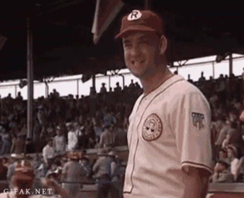 A Man In A Baseball Uniform And Hat Is Standing In Front Of A Crowd . GIF