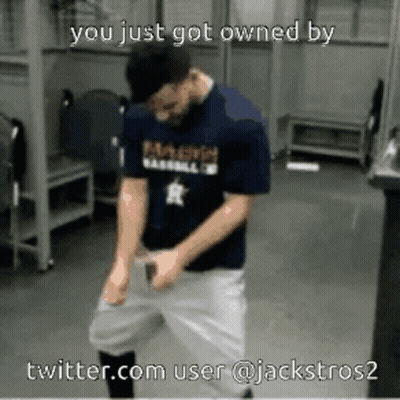 A Man In A Baseball Uniform Is Dancing In A Locker Room GIF