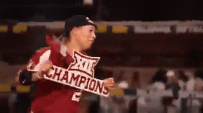 A Man In A Baseball Uniform Is Holding A Sign That Says Champions . GIF