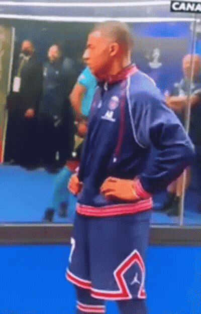 A Man In A Basketball Uniform With The Number 7 On His Shorts Is Standing With His Hands On His Hips . GIF