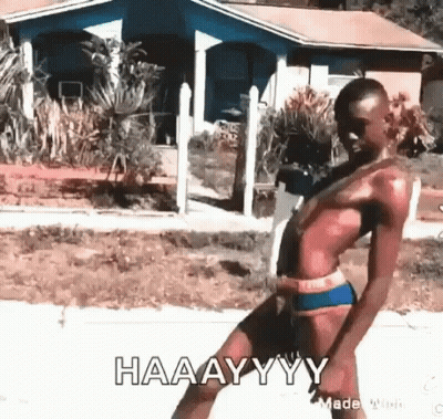 A Man In A Bathing Suit Is Dancing In Front Of A House And Says Haaayyy . GIF