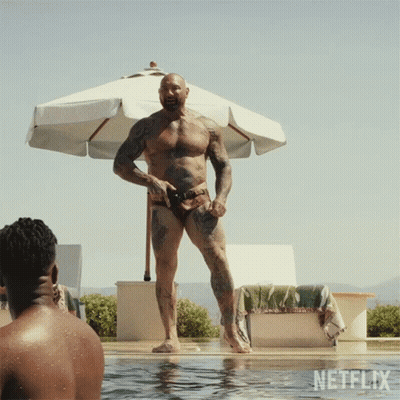 A Man In A Bathing Suit Is Standing In A Pool With Netflix Written On The Bottom GIF
