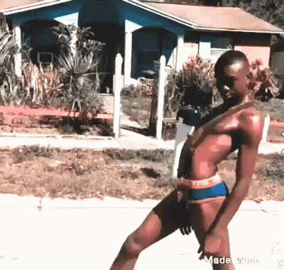 A Man In A Bathing Suit Is Standing In Front Of A House With The Words Made With Watermark At The Bottom GIF