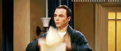A Man In A Bathrobe Is Holding A Piece Of Paper In His Hand . GIF