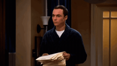A Man In A Bathrobe Is Holding A Piece Of Paper GIF