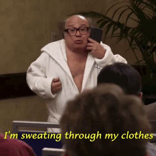 A Man In A Bathrobe Is Sweating Through His Clothes And Talking On A Cell Phone GIF