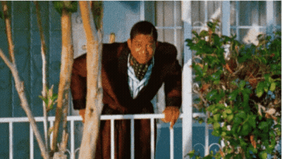 A Man In A Bathrobe Leans Over A Railing GIF