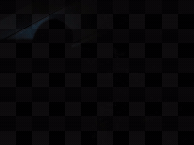 A Man In A Batman Costume Stands In The Dark GIF
