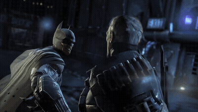 A Man In A Batman Costume Talks To Another Man GIF