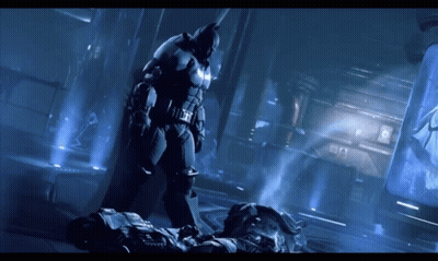 A Man In A Batman Suit Is Standing Next To Another Man GIF