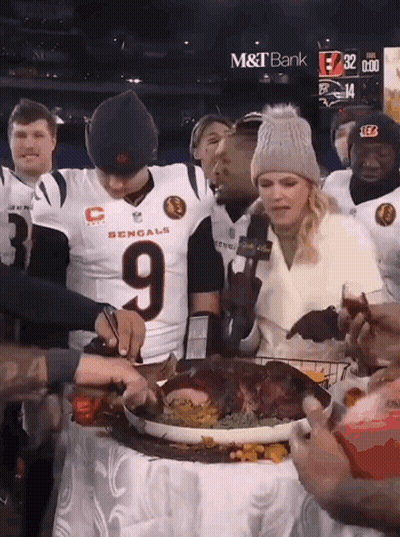 A Man In A Bengals Jersey Cuts A Turkey GIF