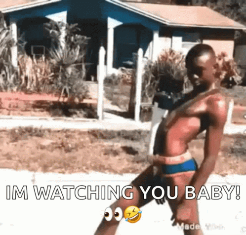 A Man In A Bikini Is Standing In Front Of A House And Says I 'M Watching You Baby ! GIF