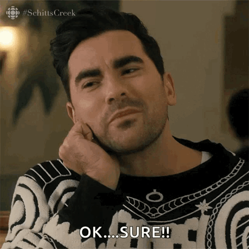 A Man In A Black And White Sweater Is Saying Ok Sure GIF
