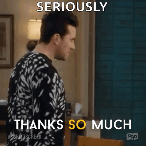 A Man In A Black And White Sweater Is Standing In A Living Room And Says `` Seriously Thanks So Much '' . GIF