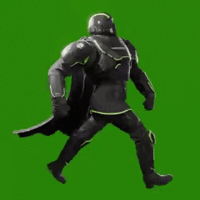 A Man In A Black Armor Is Walking On A Green Screen . GIF