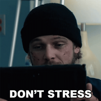 A Man In A Black Beanie Is Looking At A Tablet With The Words " Do N't Stress " On The Bottom GIF