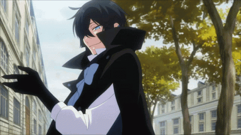 A Man In A Black Cape And White Shirt Is Standing In Front Of A Building GIF