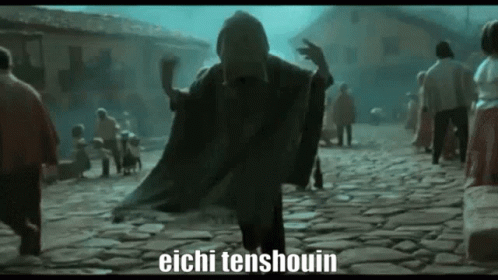A Man In A Black Cape Is Walking Down A Cobblestone Street With People Behind Him . GIF