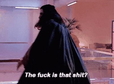 A Man In A Black Cape Is Walking In A Room And Says The Fuck Is That Shit . GIF