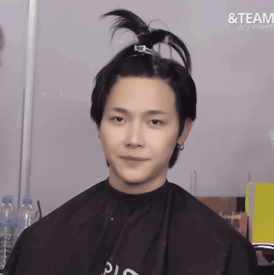 A Man In A Black Cape With The Word Team Written On The Bottom GIF