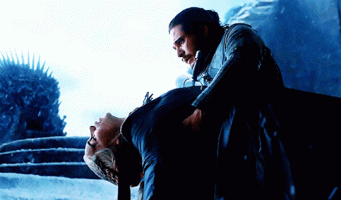 A Man In A Black Coat Is Carrying Another Man GIF
