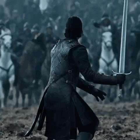 A Man In A Black Coat Is Holding A Sword In Front Of A Crowd Of Horses . GIF