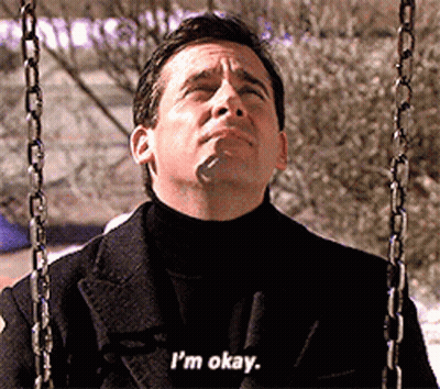 A Man In A Black Coat Is Sitting On A Swing And Says I 'M Okay GIF