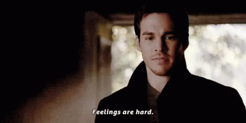 A Man In A Black Coat Is Standing In A Dark Room And Saying `` Feelings Are Hard . '' GIF
