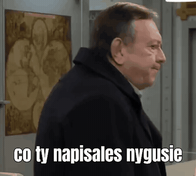 A Man In A Black Coat Is Standing In Front Of A Wall With A Painting On It . GIF