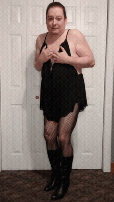 A Man In A Black Dress And Black Boots Stands In Front Of A Door GIF